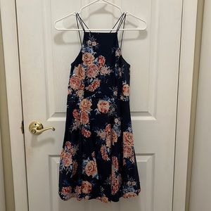 Dark blue floral short dress. Crosses In the back. Size S.